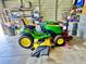 John Deere E180 lawn tractor is parked in the garage at 11268 Shivering Owl Ave, Weeki Wachee, FL 34614