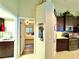 Hallway view between the laundry room and bedroom with kitchen features at 11268 Shivering Owl Ave, Weeki Wachee, FL 34614