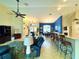Open-concept living area featuring bar seating, a dining area, and comfortable leather furniture at 11268 Shivering Owl Ave, Weeki Wachee, FL 34614