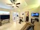 Bright living room with french doors, a ceiling fan, tile flooring, and comfortable furnishings at 11268 Shivering Owl Ave, Weeki Wachee, FL 34614