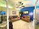Inviting living room showcasing comfortable leather seating, a mirror, and a view into another room at 11268 Shivering Owl Ave, Weeki Wachee, FL 34614