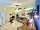 Spacious living room offering comfortable seating, a ceiling fan, and an adjacent office space at 11268 Shivering Owl Ave, Weeki Wachee, FL 34614