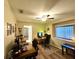Home office with wood floors, ceiling fan, and windows for natural light at 11268 Shivering Owl Ave, Weeki Wachee, FL 34614