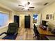Home office space featuring wood floors, a ceiling fan, and natural light from window at 11268 Shivering Owl Ave, Weeki Wachee, FL 34614