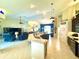 Bright, open floor plan showcasing the modern kitchen, dining area, and living room layout with high ceilings at 11268 Shivering Owl Ave, Weeki Wachee, FL 34614