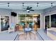 Charming covered patio features a ceiling fan, outdoor seating, and views of the pool, ideal for outdoor relaxation at 11268 Shivering Owl Ave, Weeki Wachee, FL 34614