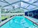 Refreshing screened-in pool with patio area, offering a private outdoor oasis for relaxation and recreation at 11268 Shivering Owl Ave, Weeki Wachee, FL 34614