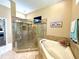 Main bathroom featuring a glass walk-in shower with bench and spa-like finishes at 11268 Shivering Owl Ave, Weeki Wachee, FL 34614
