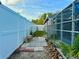 Fenced yard with walkway by the screened in pool area at 11268 Shivering Owl Ave, Weeki Wachee, FL 34614
