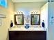 Dual granite vanities feature plenty of counter space and lighting in the bathroom at 11268 Shivering Owl Ave, Weeki Wachee, FL 34614