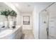 Well-lit bathroom showcasing double sinks, granite counters and a glass-enclosed shower at 12440 Gust Ct, Hudson, FL 34669