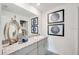 Stylish bathroom vanity with granite counters, dual sinks, decorative mirrors and tasteful decor at 12440 Gust Ct, Hudson, FL 34669