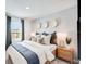 Comfortable primary bedroom with a large window, plush bedding, and stylish accents at 12440 Gust Ct, Hudson, FL 34669