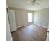 Bedroom with hardwood flooring, a ceiling fan, and a window to let in natural light at 12604 Montford Ln, Riverview, FL 33579