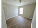 Bright bedroom featuring hardwood floors, a ceiling fan and neutral-toned walls at 12604 Montford Ln, Riverview, FL 33579