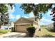 Two-story home showcasing a two-car garage in a suburban setting with lush landscaping at 12604 Montford Ln, Riverview, FL 33579