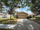 Traditional two-story house with attached garage and mature trees in a desirable neighborhood at 12604 Montford Ln, Riverview, FL 33579