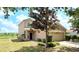 Inviting two-story home with a well-manicured lawn, mature tree and attached two-car garage at 12604 Montford Ln, Riverview, FL 33579