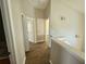 Hallway featuring hardwood floors and neutral-toned walls with decorative light fixtures at 12604 Montford Ln, Riverview, FL 33579