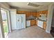 Functional kitchen with white appliances, tiled floors, and ample cabinet space at 12604 Montford Ln, Riverview, FL 33579