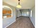 Spacious living room features modern wood floors and an open layout leading to the kitchen at 12604 Montford Ln, Riverview, FL 33579