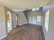 Open-concept living room boasts new wood floors, arched doorways, and bright windows at 12604 Montford Ln, Riverview, FL 33579