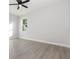 A bright bedroom with light gray flooring and a ceiling fan for comfortable living at 13451 Kaplan Ter, Port Charlotte, FL 33981