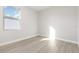 An empty bright room with light gray flooring and a large window at 13451 Kaplan Ter, Port Charlotte, FL 33981
