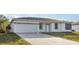 Well-maintained house with a brick-paved driveway and attached two-car garage at 13451 Kaplan Ter, Port Charlotte, FL 33981