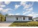 Charming single-story home with well-kept lawn and an attached two-car garage at 13451 Kaplan Ter, Port Charlotte, FL 33981