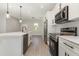 Modern kitchen island boasts a stainless steel dishwasher and black faucet, plenty of storage at 13451 Kaplan Ter, Port Charlotte, FL 33981