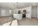 Modern kitchen features stainless steel appliances, a central island, and an open floor plan at 13451 Kaplan Ter, Port Charlotte, FL 33981