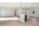 A modern open-concept floor plan with large living space and kitchen island with stainless appliances at 13451 Kaplan Ter, Port Charlotte, FL 33981