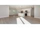 Open-concept floor plan with modern light gray flooring, a kitchen island, and lots of light at 13451 Kaplan Ter, Port Charlotte, FL 33981