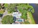 Aerial view of the home, highlighting the screened pool and the serene canal-front property at 1422 Pinebrook Dr, Clearwater, FL 33755