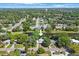 Aerial view of the home at 1422 Pinebrook Dr, nestled among mature trees and a serene canal at 1422 Pinebrook Dr, Clearwater, FL 33755
