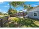 Fenced backyard with a screened-in pool, perfect for relaxing or entertaining at 1422 Pinebrook Dr, Clearwater, FL 33755