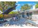 Charming backyard patio with dining set, lounge chairs, and shade umbrella for outdoor enjoyment at 1422 Pinebrook Dr, Clearwater, FL 33755