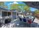Outdoor patio area with dining table, seating, grill, and screened pool area at 1422 Pinebrook Dr, Clearwater, FL 33755