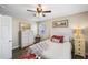 Bright bedroom with wood-look floors, white bedding, and natural light from multiple windows at 1422 Pinebrook Dr, Clearwater, FL 33755