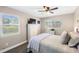 Bright bedroom with a ceiling fan, two windows and a chest of drawers at 1422 Pinebrook Dr, Clearwater, FL 33755