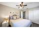 Inviting bedroom with ceiling fan, closet, and soft lighting at 1422 Pinebrook Dr, Clearwater, FL 33755