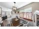 Cozy dining area with a dark wood table, white wainscoting, and decorative floral curtains at 1422 Pinebrook Dr, Clearwater, FL 33755