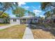 Inviting single-story home with a well-manicured lawn and sidewalk leading to the front entrance at 1422 Pinebrook Dr, Clearwater, FL 33755