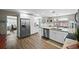 Bright, open kitchen featuring stainless steel appliances and hardwood floors at 1422 Pinebrook Dr, Clearwater, FL 33755