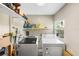 Functional laundry room featuring updated machines, shelving, and natural light from a window at 1422 Pinebrook Dr, Clearwater, FL 33755