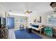Bright living area with wood floors, blue rug, natural light, and comfortable seating arrangement at 1422 Pinebrook Dr, Clearwater, FL 33755