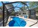 Backyard featuring a sparkling private pool with a screened enclosure and outdoor seating area at 1422 Pinebrook Dr, Clearwater, FL 33755