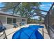 Inviting screened-in pool area offers a private retreat with views of the backyard and surrounding landscape at 1422 Pinebrook Dr, Clearwater, FL 33755