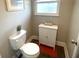 Cozy powder room featuring a toilet and cabinet at 1422 Pinebrook Dr, Clearwater, FL 33755